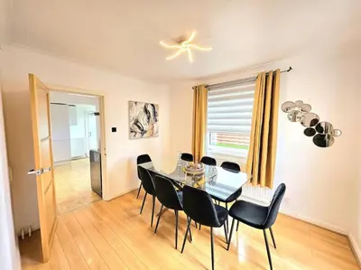 a dining room with a glass table and black chairs at 3 Bed House with 6 Beds by Sensational Stay in Edinburgh