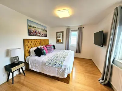 a bedroom with a large bed in a room at 3 Bed House with 6 Beds by Sensational Stay in Edinburgh