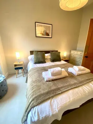 a bedroom with two beds with towels on them at Ochil View in Stirling