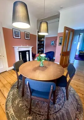 a dining room with a wooden table and chairs at Ochil View in Stirling