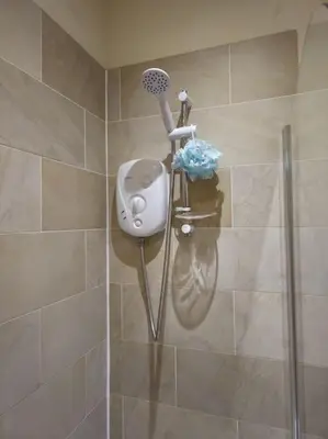 a shower with a hair dryer in a bathroom at 2 Bedroom Modern stylish Apt in Glasgow City Centre in Glasgow