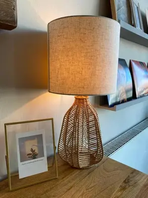 a lamp sitting on a table next to a picture at Luxury Huge Modern Open Plan 2Bedroom Flat - Free Private Parking & Balcony located at the OVO Hydro and SEC Centre in Glasgow