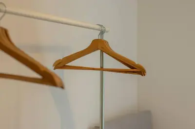 a wooden hanger is hanging from a wall at 2 bed flat near airport &parking in Paisley