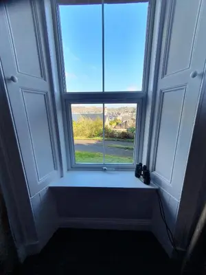 a window in a room with a view of a field at McCaig's View in Oban
