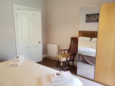 a room with a mirror and a bed and a mirror at McCaig's View in Oban