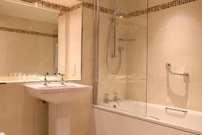 a bathroom with a shower and a sink and a shower at Macdonald Forest Hills Hotel & Spa in Aberfoyle