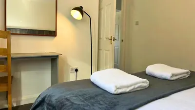 a room with a bed with two white towels on it at Jura in Oban