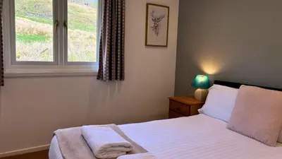 a bedroom with a bed and a window at Skye in Oban