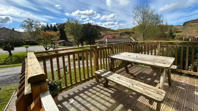 a wooden bench sitting on top of a wooden fence at Skye in Oban