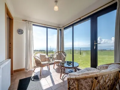 a living room with a couch and chairs and large windows at Barnstable - Uk46888 in Kilmory