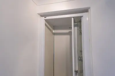 a bathroom with a shower and a mirror at Whiteside Apartment in Bathgate