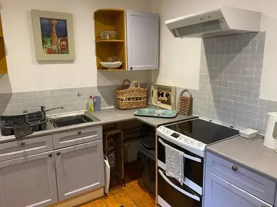 a small kitchen with a sink and a stove at Christmas Cottage in Balmaha