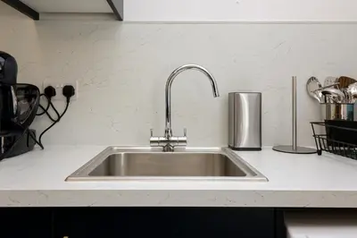 a stainless steel kitchen sink in a kitchen at Meadowfoot Haven in West Kilbride