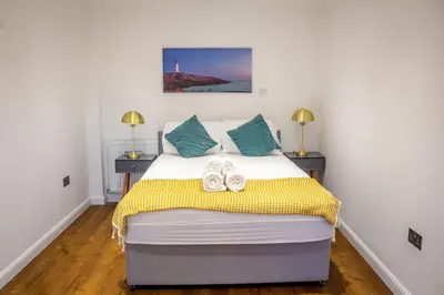 a bedroom with a bed with shoes on it at 4 Bed complete Home in Edinburgh Near Airport in Edinburgh