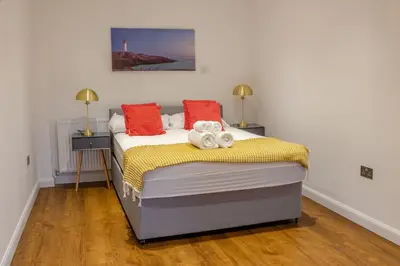 a bedroom with a bed with two stuffed animals on it at 4 Bed complete Home in Edinburgh Near Airport in Edinburgh