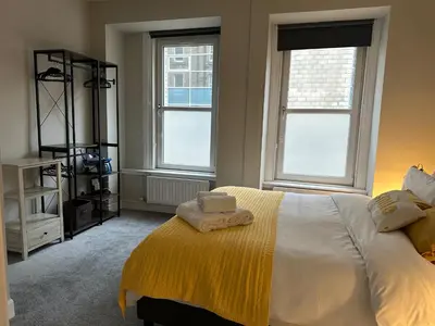 a bedroom with a bed with two towels on it at Two bed apartment in Edinburgh