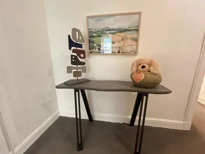 a teddy bear sitting on a table with a basket at Two bed apartment in Edinburgh