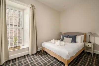a bedroom with a bed and a window at Adam Drysdale House in Edinburgh