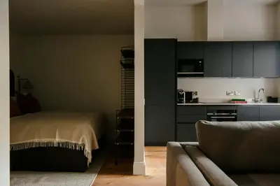 a living room with a bed and a kitchen at 33 Castle Terrace in Edinburgh
