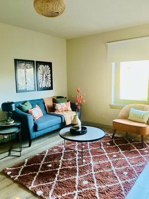 a living room with a blue couch and a table at Castle Gait Apartment in Paisley