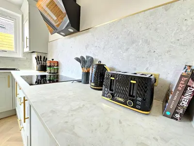 a kitchen with a white counter top with a toaster at Newly Renovated Gem - Free Parking & Modern Comfort in Glasgow