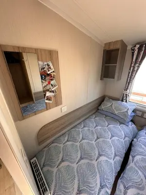 a bedroom with a bed in a small room at 3-Bedroom Swift Caravan - Located in Uddingston, Glasgow at Maryville Caravan Site in Glasgow