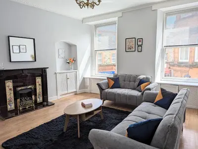 a living room with a couch and a fireplace at Campbeltown Central in Campbeltown
