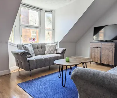 a living room with a couch and a table at Campbeltown Central in Campbeltown
