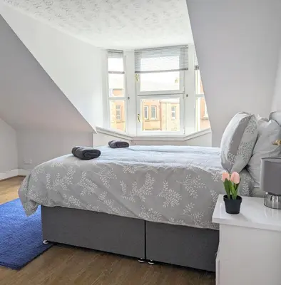 a bedroom with a bed and a window at Campbeltown Central in Campbeltown
