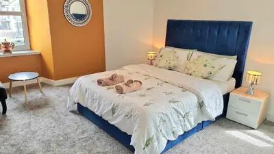 a bedroom with a bed with two towels on it at The Rest in Tarbert