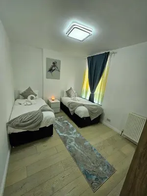 a bedroom with two beds and a window at Lovely house with private parking! Glasgow! in Glasgow