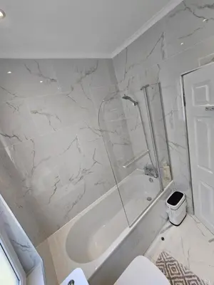 a white bathroom with a shower and a toilet at Lovely house with private parking! Glasgow! in Glasgow