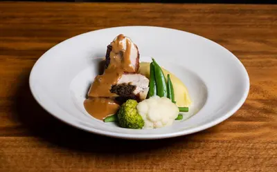a plate of food with meat and vegetables on a table at Green Hotel, a member of Radisson Individuals in Kinross