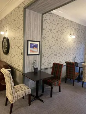 a waiting room with a table and chairs at Green Hotel, a member of Radisson Individuals in Kinross