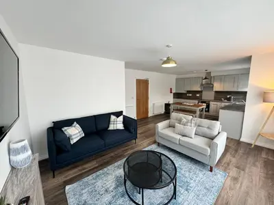 a living room with a couch and a table at Inchtavannach Apartment 1/1 in Bonhill