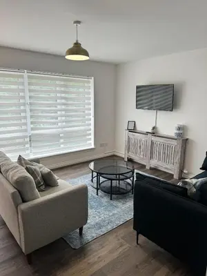 a living room with a couch and a table at Inchtavannach Apartment 1/1 in Bonhill