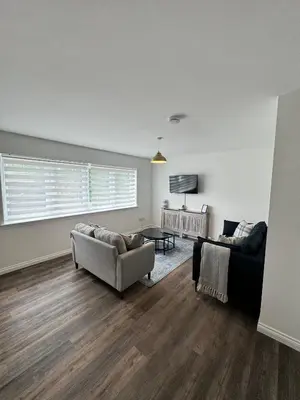 a living room with a couch and a chair at Inchmoan Apartment in Bonhill