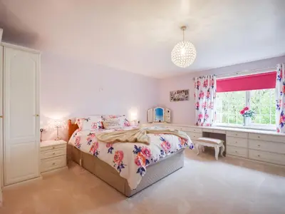 a bedroom with a bed and a window at Nether Auchlinsky Cottage in Glendevon
