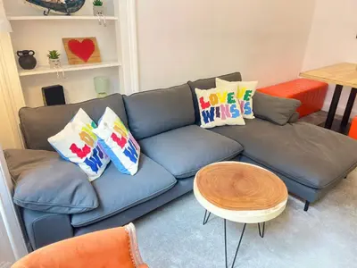 a blue couch with pillows on it in a living room at Lovely two bedrooms in Edinburgh