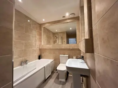 a bathroom with a tub and a toilet and a sink at Lovely two bedrooms in Edinburgh