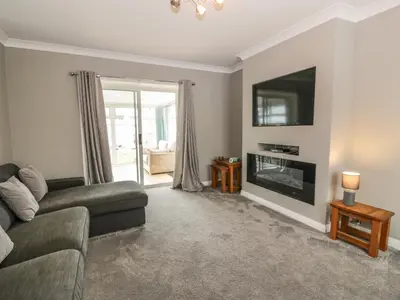 a living room with a couch and a television at Largieholm in Mauchline