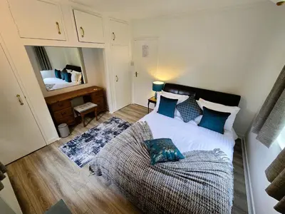 a bedroom with a bed with blue pillows at Ard Veich Estate - Panoramic Highland Sea Views with private beach and woodland in Port Appin