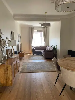 a living room with a couch and a table at Inverbeg Cottage in Rothesay