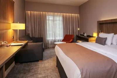a hotel room with a large bed and a desk at Best Western Motherwell Centre Moorings Hotel in Motherwell