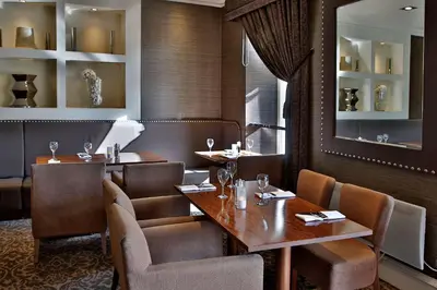 a restaurant with tables and chairs and a mirror at Best Western Motherwell Centre Moorings Hotel in Motherwell