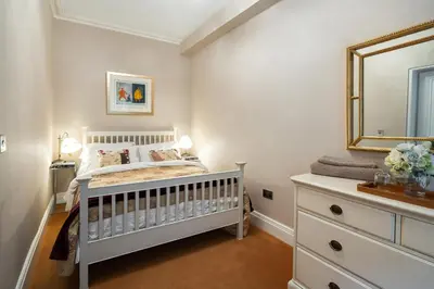 a baby bedroom with a crib and a mirror at Number 10 in Edinburgh