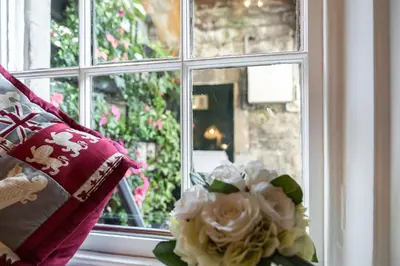 a vase of flowers sitting on a window sill at Number 10 in Edinburgh