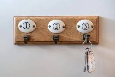 a wooden holder with two keys on a wall at Number 10 in Edinburgh