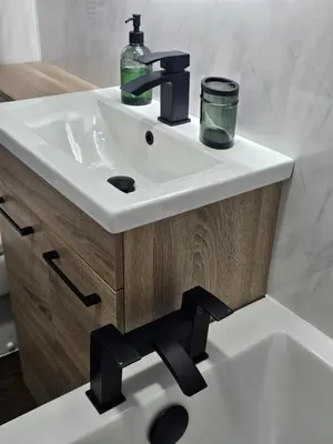 a white bathroom sink with a black faucet at Glebe Apartment in Campbeltown