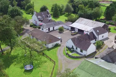 an aerial view of a large house with a yard at Courtyard Cottages Granary Cottage in Wigtown